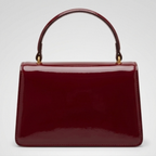 Maroon Gucci Dionysus top handle bag with a silver-tone tiger head closure.