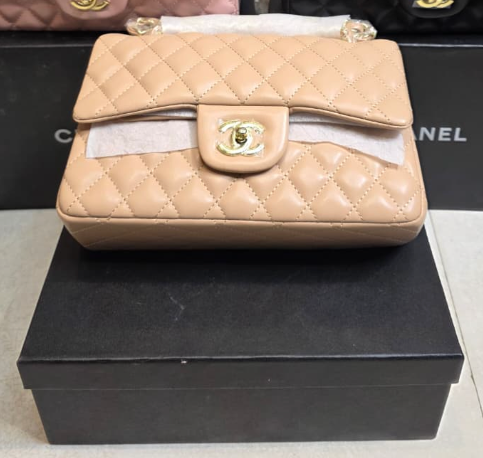Chanel Mini Flap Bag in Apricot lambskin leather with a gold-tone chain strap and CC turn-lock