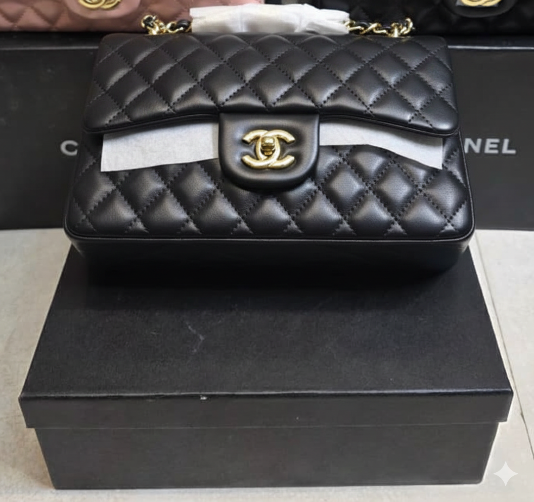 Chanel Mini Flap Bag in black lambskin leather with a gold-tone chain strap and CC turn-lock