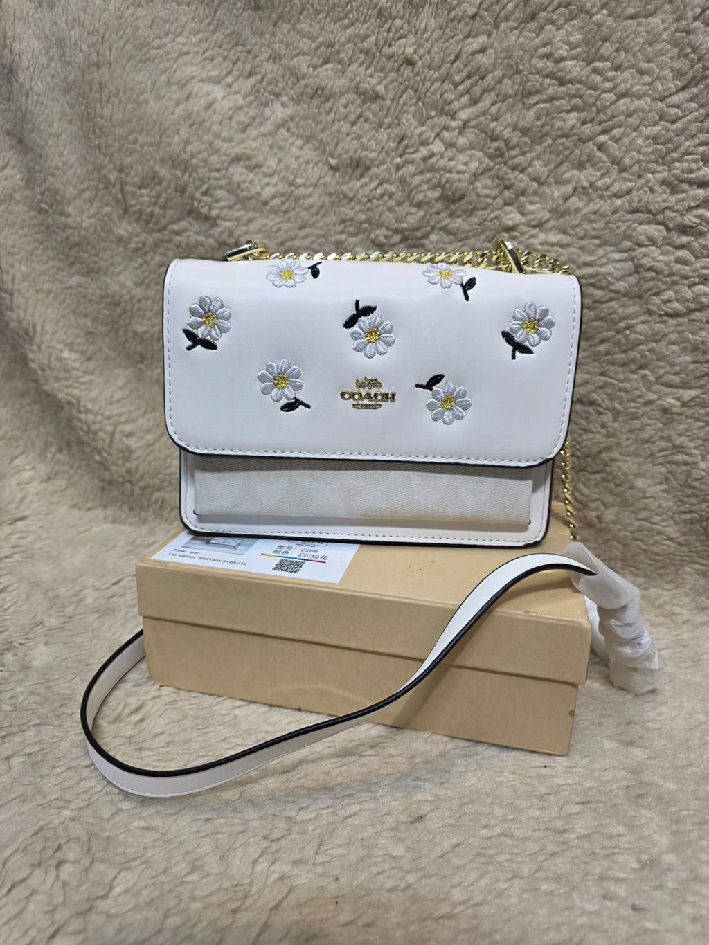 Coach Klare crossbody bag with daisy embroidery in white smooth leather with a gold-tone chain strap