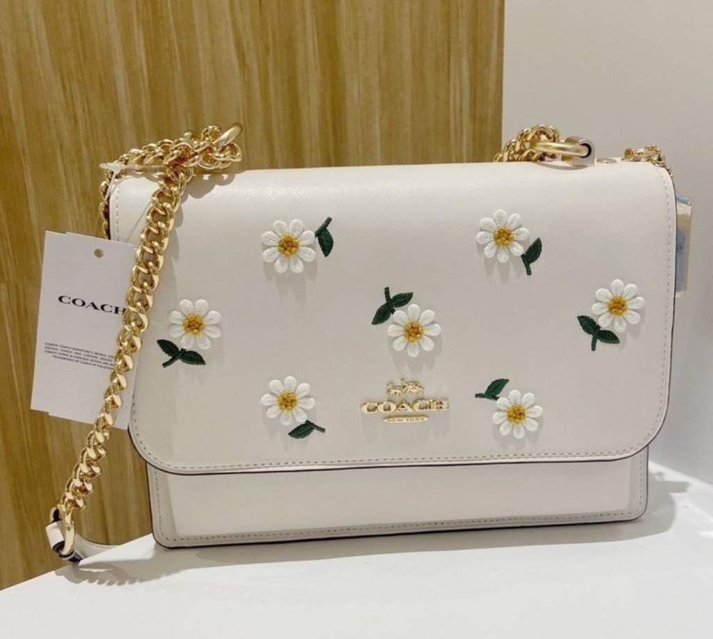 Coach Klare crossbody bag with daisy embroidery in white smooth leather with a gold-tone chain strap