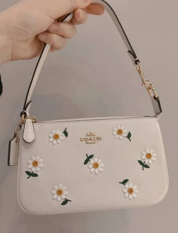 Coach Nolita 19 with Daisy Embroidery in refined pebble leather and white color.