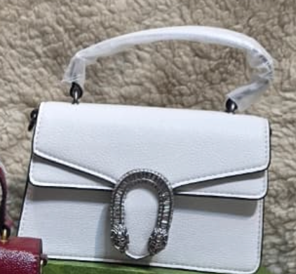 white Gucci Dionysus top handle bag with a silver-tone tiger head closure.